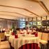 Zhuhai Zobon Art Hotel in Zhuhai restaurant with round tables, red napkins and mirrored walls