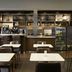 Courtyard by Marriott San Mateo Foster City lobby café with tables, stools, and a drink cooler