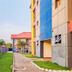 Rhogem Hotel in Takoradi with landscaped walkway, palm trees and colorful hotel buildings