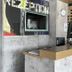 ibis budget Köln Leverkusen City reception desk with computer and concrete wall in Leverkusen