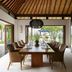 The Ungasan Clifftop Resort in South Kuta dining room with open garden views and a long wooden table