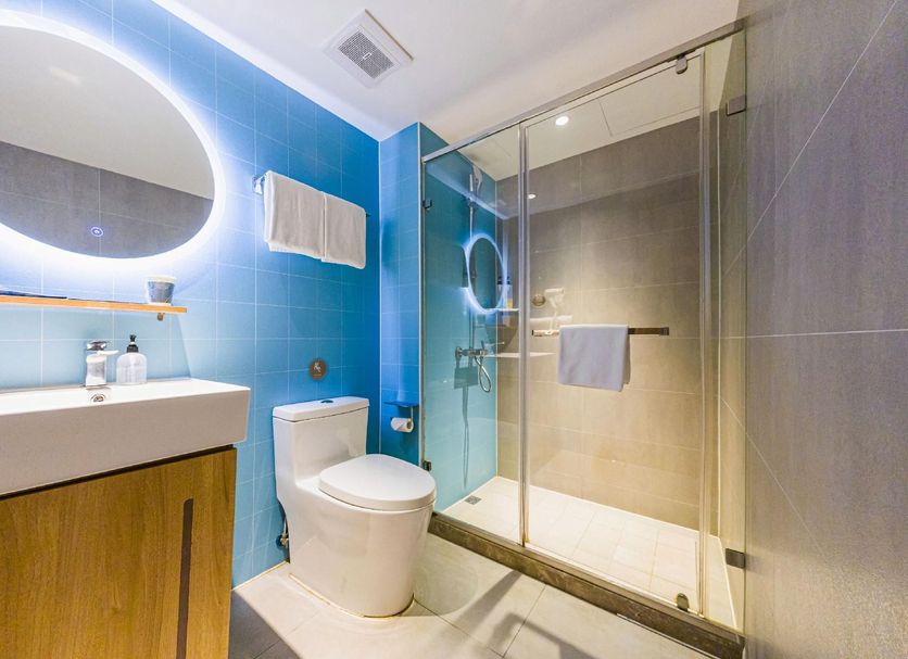 Home Inn Neo Shenzhen Dongmen Pedestrian Street Shaibu Metro Station bathroom with glass shower and blue tile in Shenzhen