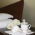 B&B Gildo Trani room with bed and tea set on a bedside table