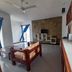 Aqua Resort in Diani Beach living area with TV wall, sofa, and kitchenette counter
