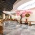 Haili Garden Hotel Guangzhou lobby lounge with dining tables, glossy marble floor and pink blossom decor