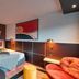 Zenitude Hotel Residences - Grenoble Alpexpo room with bed, desk, chair, and modern abstract wall art
