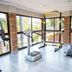 Boksburg Boutique Hotel gym in Boksburg with treadmill, step platform and weight station by large windows