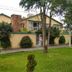Hostal Bogotá Real in Bogotá, exterior view with landscaped lawn and trees