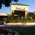Oakwood Falls Church exterior entrance with landscaped planters and clear blue sky in Falls Church