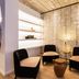 ibis Styles Frankfurt City lounge with black chairs, glass tables and tiled wall in Frankfurt am Main
