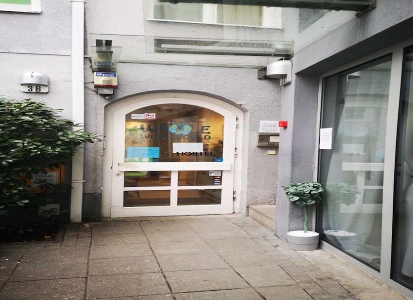 Whole Wide World Hostel Zagreb entrance courtyard with glass doors and potted plant