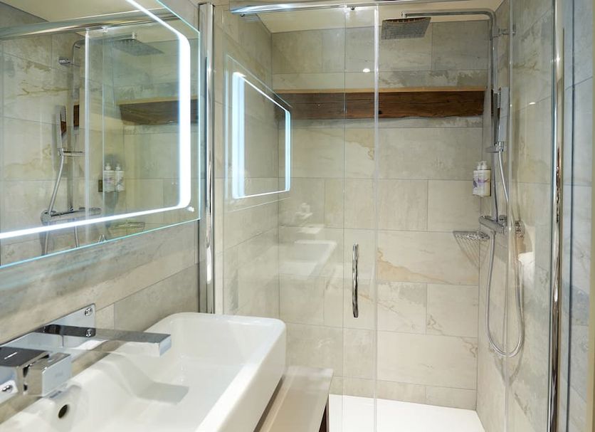 The Tickled Trout in Maidstone bathroom with glass shower, freestanding tub and lit mirror