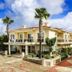 Kamer Exclusive Hotel & Suites in Cesme, exterior with palm trees and bright sky
