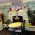 Buena Vista Inn Motel in Delhi lobby seating area with round table, chairs, and potted plants
