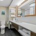 Hampton Inn Birmingham/Trussville bathroom with shower, toilet, and vanity in Trussville