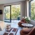 Sovn Experience+Lifestyle Cape Town room with king bed, balcony, and garden views