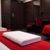 Liljeholmens Stadshotell in Stockholm room with red beds, desk, mirror and dark wood walls