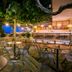 Kenta Beach Hotel in Agios Ioannis: outdoor terrace dining area with sea view and string lights