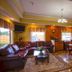 Downtowner Inn and Suites in Houston lounge with leather sofas, dining table, and kitchenette