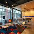 Aloft Waco Downtown lobby lounge with colorful rug, seating area, and large windows in Waco