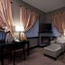 The Giacomo, an Ascend Collection Hotel in Niagara Falls: guest room with fireplace, lounge chairs and city view