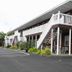 Nader's Motel & Suites in Ludington, exterior with two-story motel, white staircases and parking lot