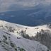 Auberge De La Poulcière in Gérardmer with snow-covered mountain slopes and cloudy alpine views