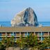 Inn at Cape Kiwanda in Pacific City with a coastal lodge facade and Haystack Rock ocean backdrop