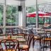 The Woodlands Inn in Wilkes-Barre dining room with large windows and red patio umbrellas