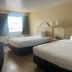 Hole Inn the Wall Hotel - Fort Walton Beach - Sunset Plaza room with two beds and a window