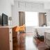 Caritas Oswald Cheung International House, Hong Kong: twin hotel room with desks, chairs and city-view window