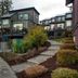 Sooke Harbour Resort & Marina in Sooke, exterior of modern guest suites with balconies and landscaped path