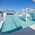 Pumicestone Blue in Caloundra rooftop pool with ocean view and glass railings