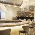 Hilton Colon Guayaquil lobby lounge with curved bar, chandelier lighting and seating in Guayaquil