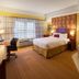 Courtyard by Marriott London room with king bed, desk, window seat and in-room bathtub