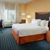 Fairfield Inn & Suites by Marriott Clarksville guest room with king bed, desk and window seating