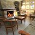 Hotel Cabanas Alto Da Serra in Canela: cozy lounge with fireplace, sofa, chairs and large windows