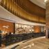 DoubleTree by Hilton Guangzhou - Science City lobby with curved marble reception desk and wood-paneled ceiling
