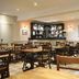 Tongadale Hotel in Portree dining room with wooden tables and chairs beside a bar