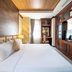 Lcs Hotel & Apartment in Phnom Penh guest room with king bed and built-in wooden TV cabinet