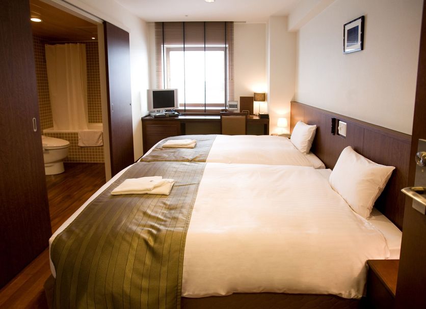 Sutton Hotel Hakata City in Fukuoka bedroom with twin beds, desk, window, and attached bathroom