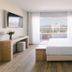 The Pearl Troia in Tróia bedroom with balcony view, wall TV, and king bed