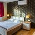 Wellness Apart Hotel Brussels guest room with double bed, city view window, and armchair