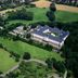 Aerial view of Kardinal Schulte Haus in Bergisch Gladbach surrounded by green fields and trees