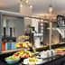 Buffet breakfast area at Leonardo Hotel Vienna Hauptbahnhof in Vienna with fruit, pastries and drink dispensers