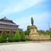Yanjiang East Garden Inn in Guangzhou with traditional Chinese building, statue and landscaped courtyard