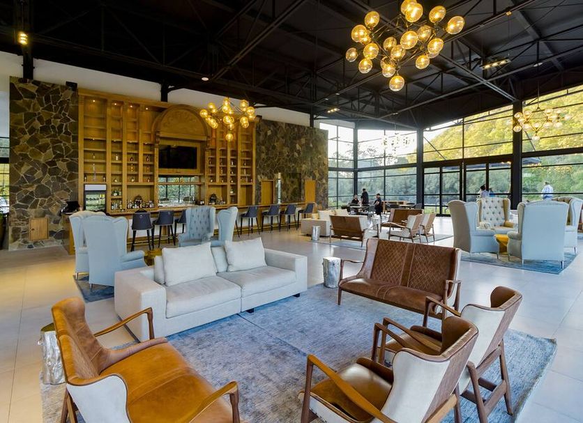 Sierra Lago in Mascota lobby lounge with chandeliers, white sofas, and large windows