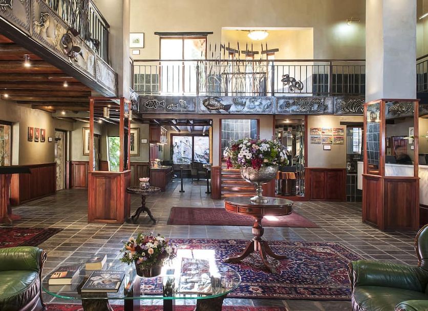 Misty Hills Country Hotel, Conference Centre & Spa lobby in Johannesburg with balcony, floral arrangements, and seating