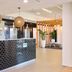Abode Woden Canberra lobby with black tiled reception desk and woven pendant lights