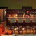 Penmaenuchaf Hotel in Dolgellau lounge bar with bar stools, lit candles and a bartender